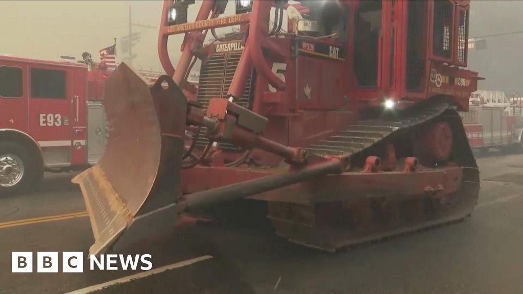 Fire department bulldozer heads down Sunset Boulevard