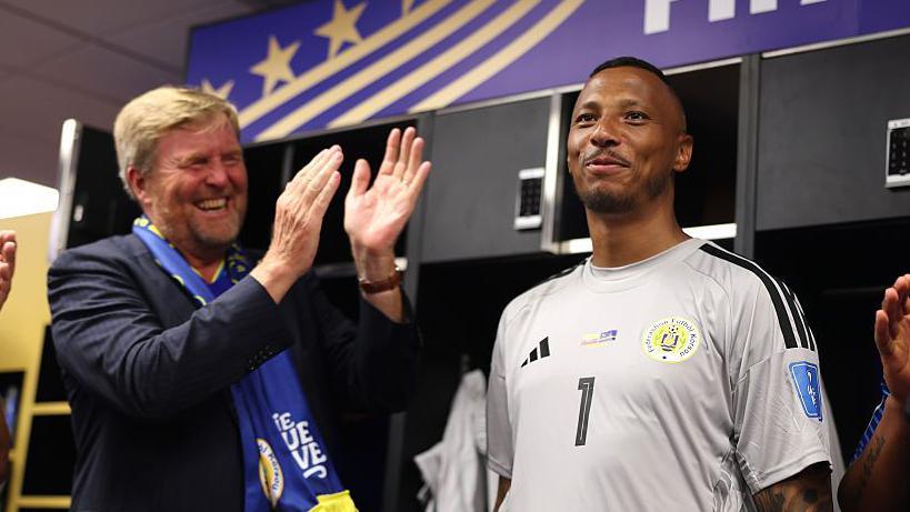King Willem-Alexander of the Netherlands and Curacao goalkeeper Eloy Room