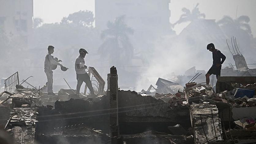 Volunteers search for possible victims in a collapsed building following twin earthquakes in Venezuela.