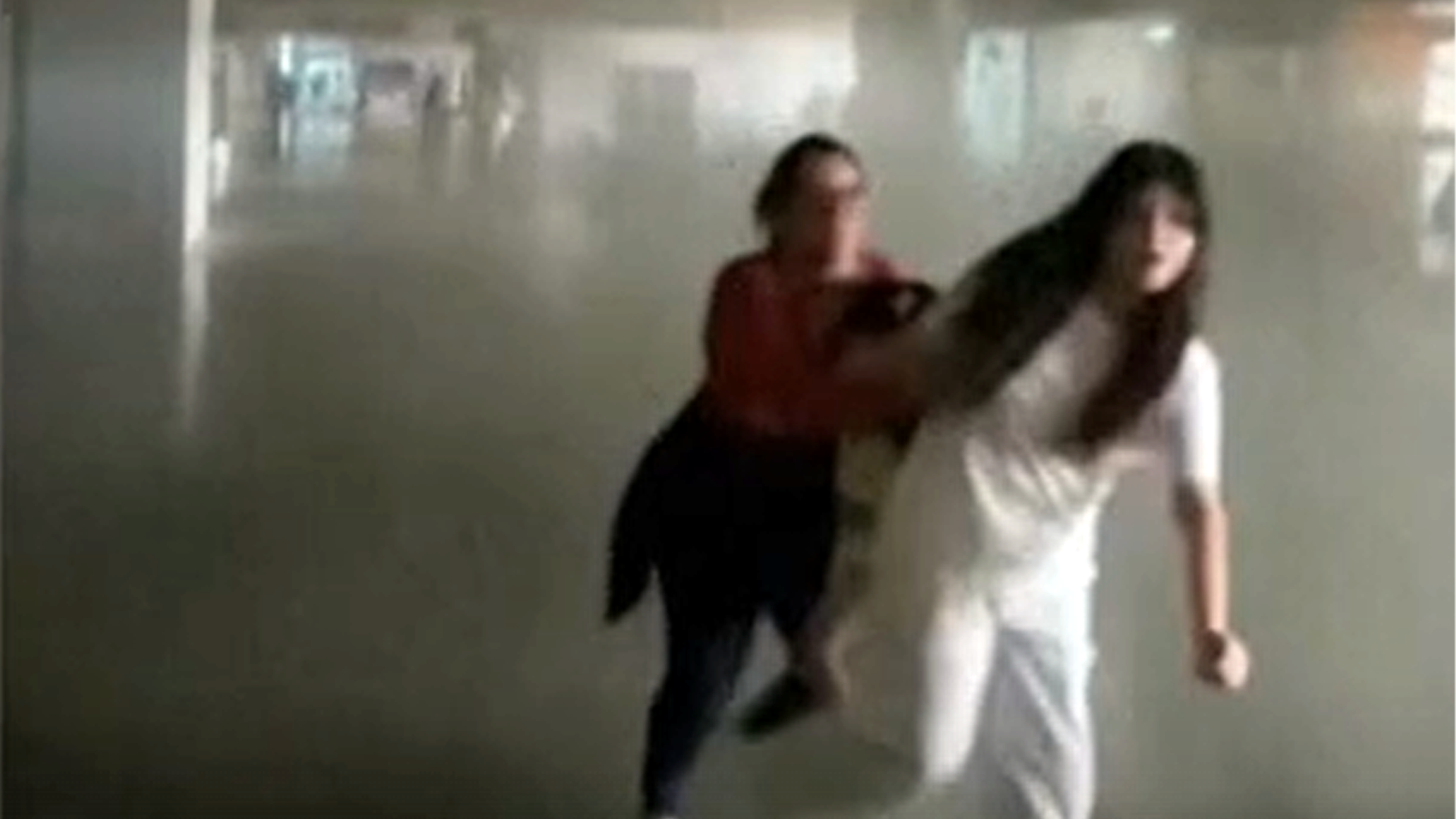 Women running as earthquake hits building