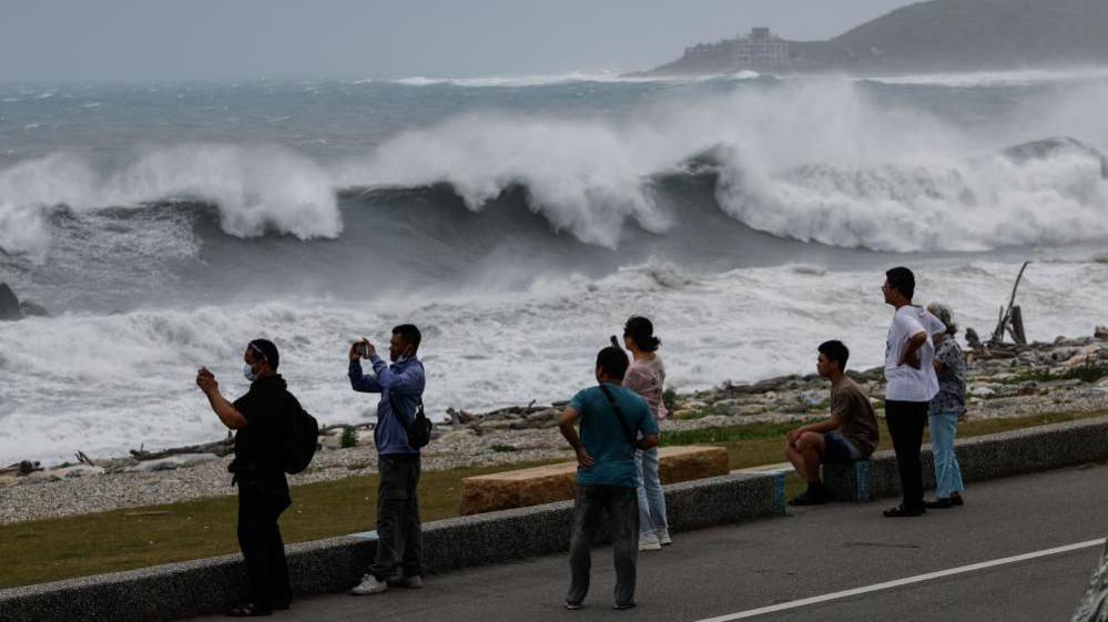 Residents observe huge waves brought by Typhoon Bavi in Hualien city, Taiwan