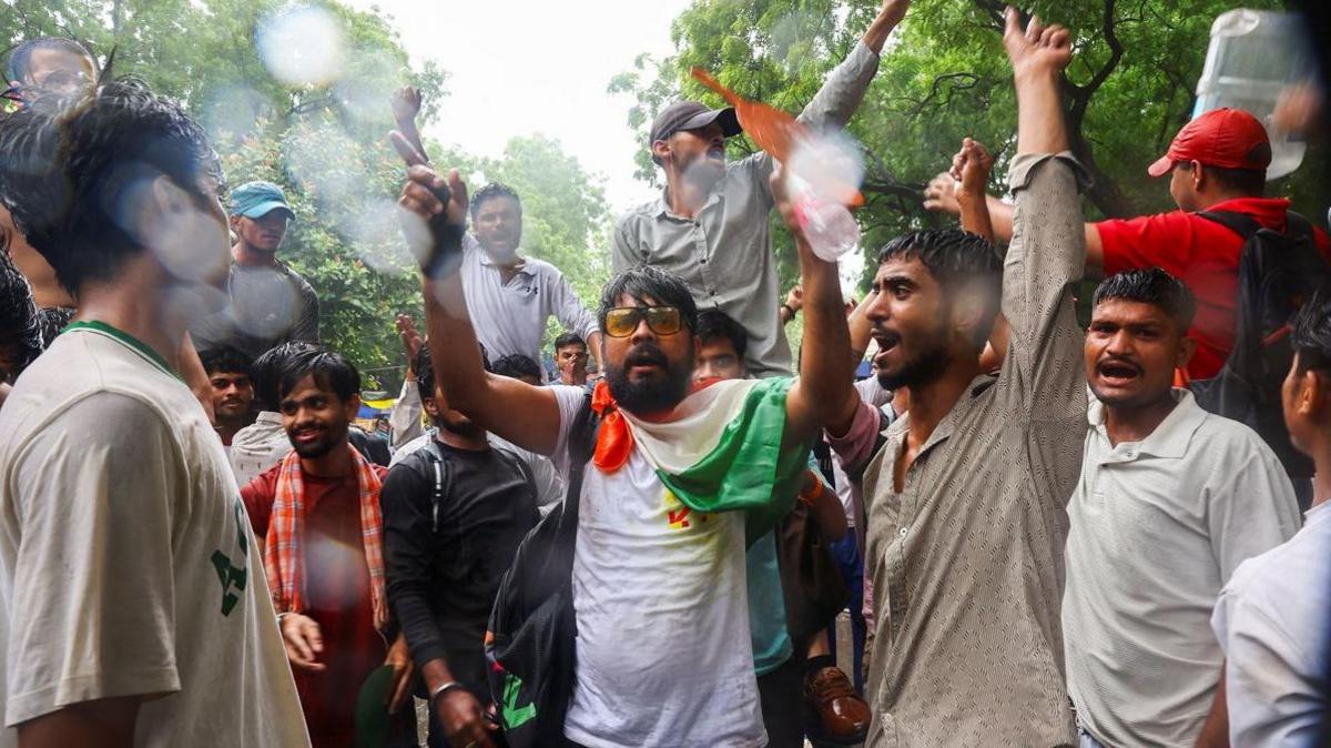 Supporters of India's Cockroach Janta Party (CJP) shout slogans, two days after thousands of protesters marched towards parliament demanding the resignation of Education Minister Dharmendra Pradhan over examination paper leaks, at Jantar Mantar in New Delhi, India, July 22, 2026.