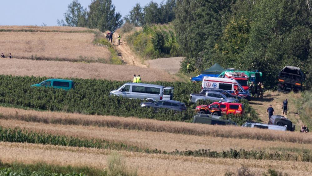 Emergency services work at the site where an unidentified flying object, believed to be a Russian cruise missile, as Ukraine's foreign minister said on Thursday, fell after violating Polish airspace