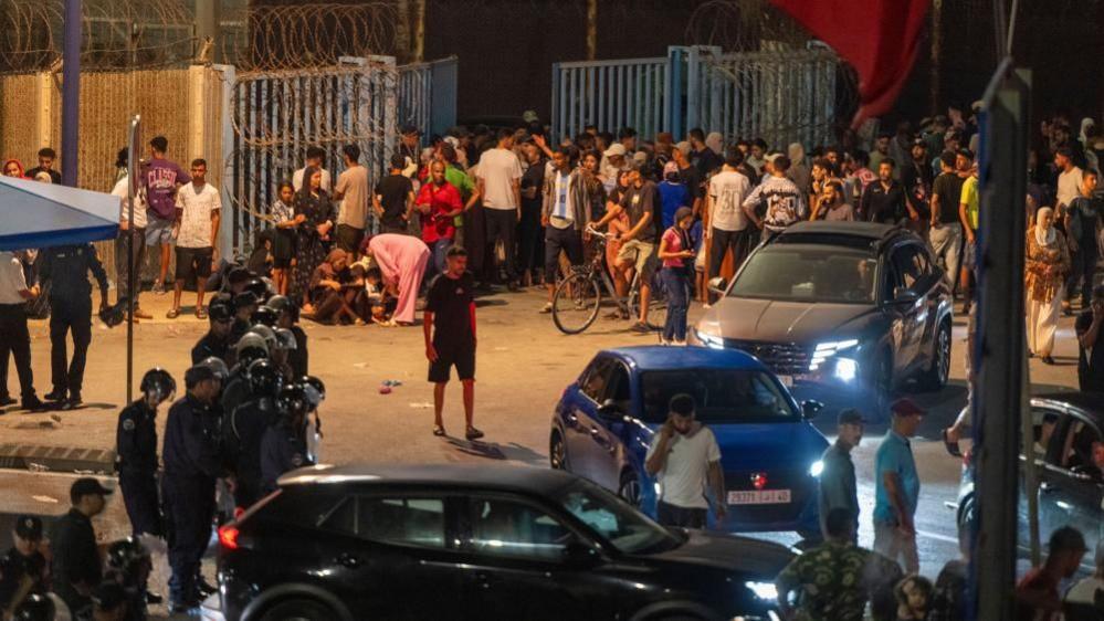 People gather at the Bab Sebta border crossing between Morocco and the Spanish enclave of Ceuta, near Fnideq, Morocc