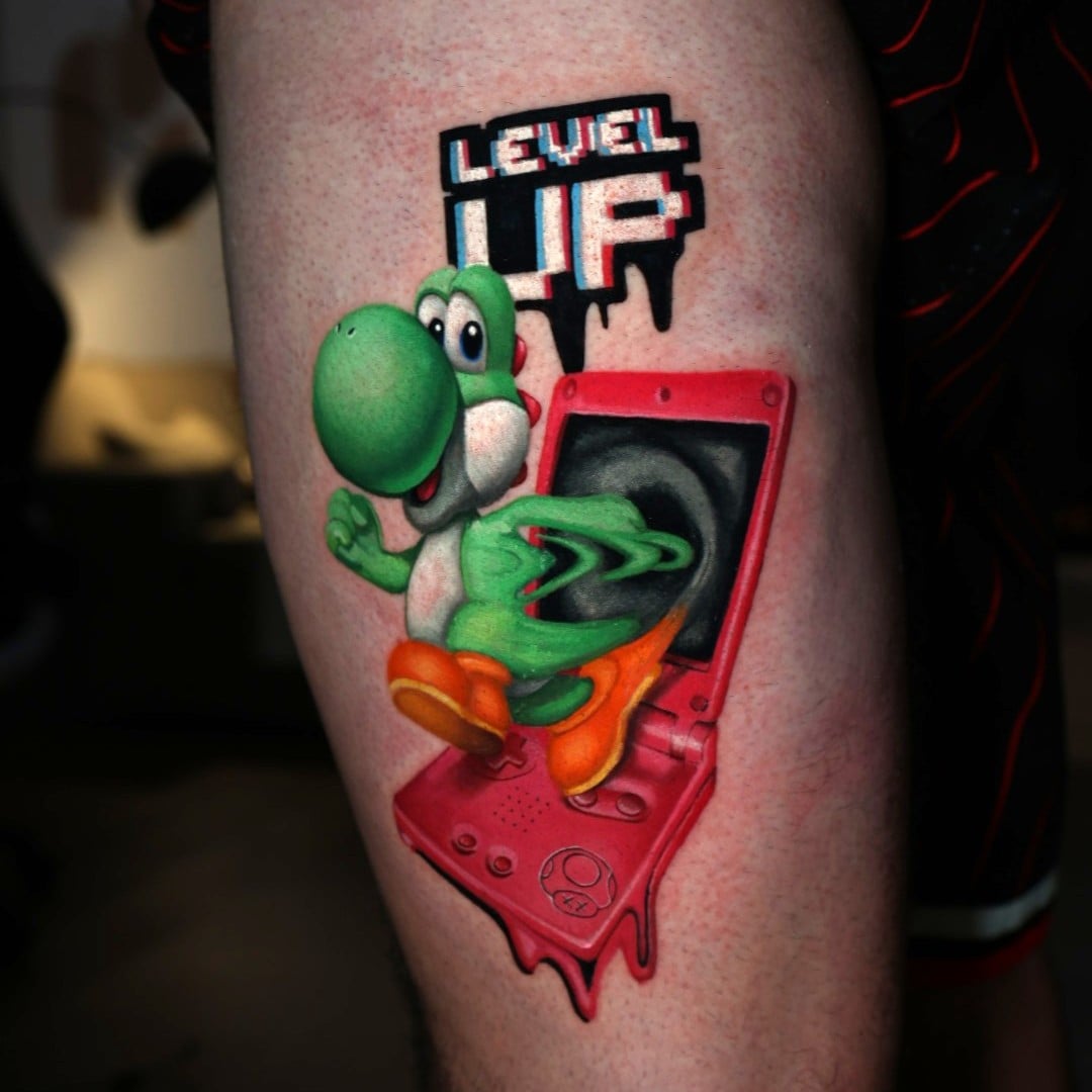 Tattoo Artist Natacha Rios On Elevating Fan Culture Into Fine Art 3 Yoshi tattoo design with "Level Up" text by tattoo artist Natacha "Nacha" Rios