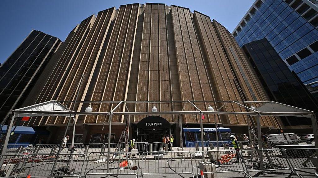 Workers put up a tent frame outside Madison Square Garden.