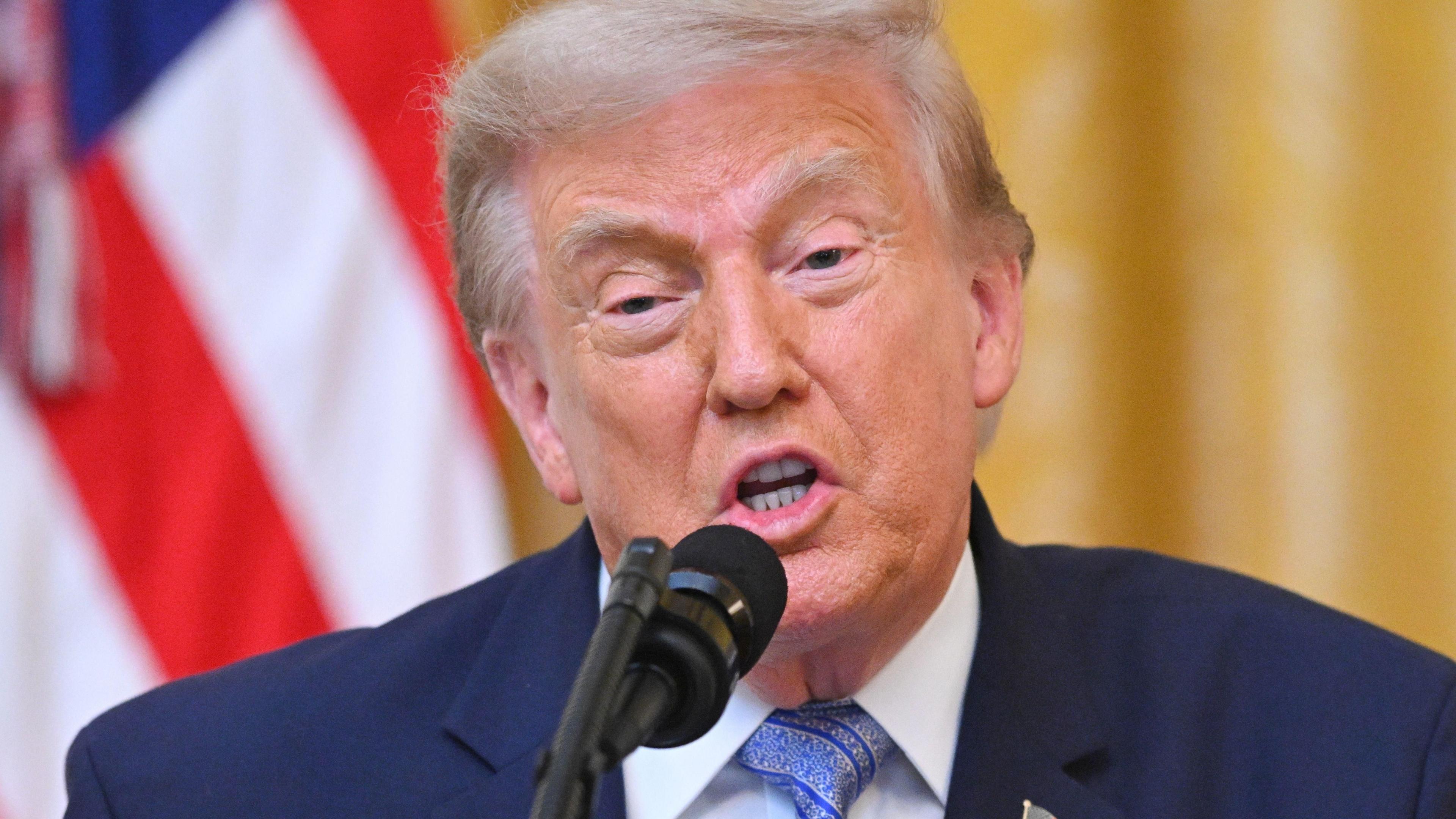 Donald Trump speaking at a podium on 16 July