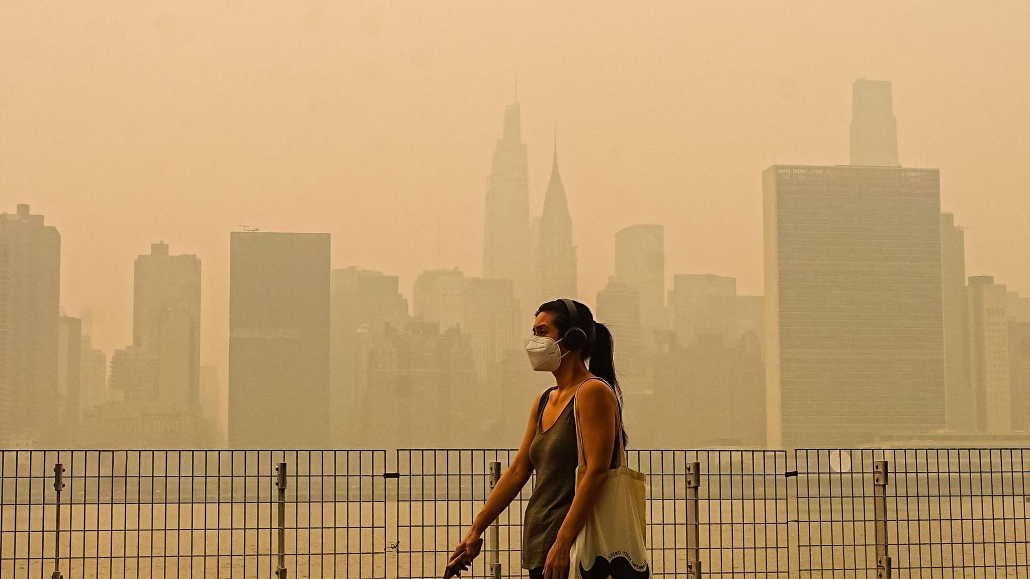 Smoke from massive wildfires in Canada engulfed the New York City skyline, reducing visibility and casting an orange haze over the New York City