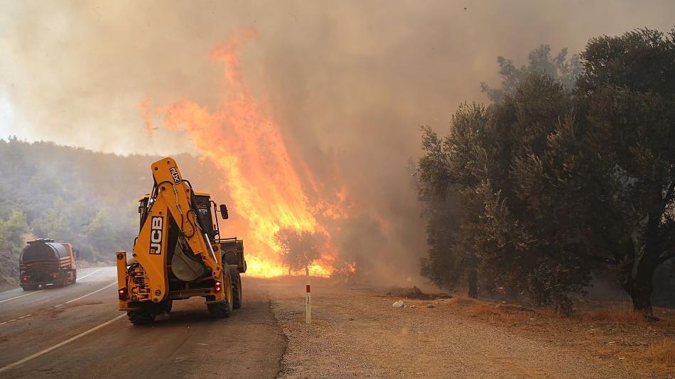 A view of flames as firefighters battle the wildfire with ground and aerial operations in Seydikemer district of Mugla