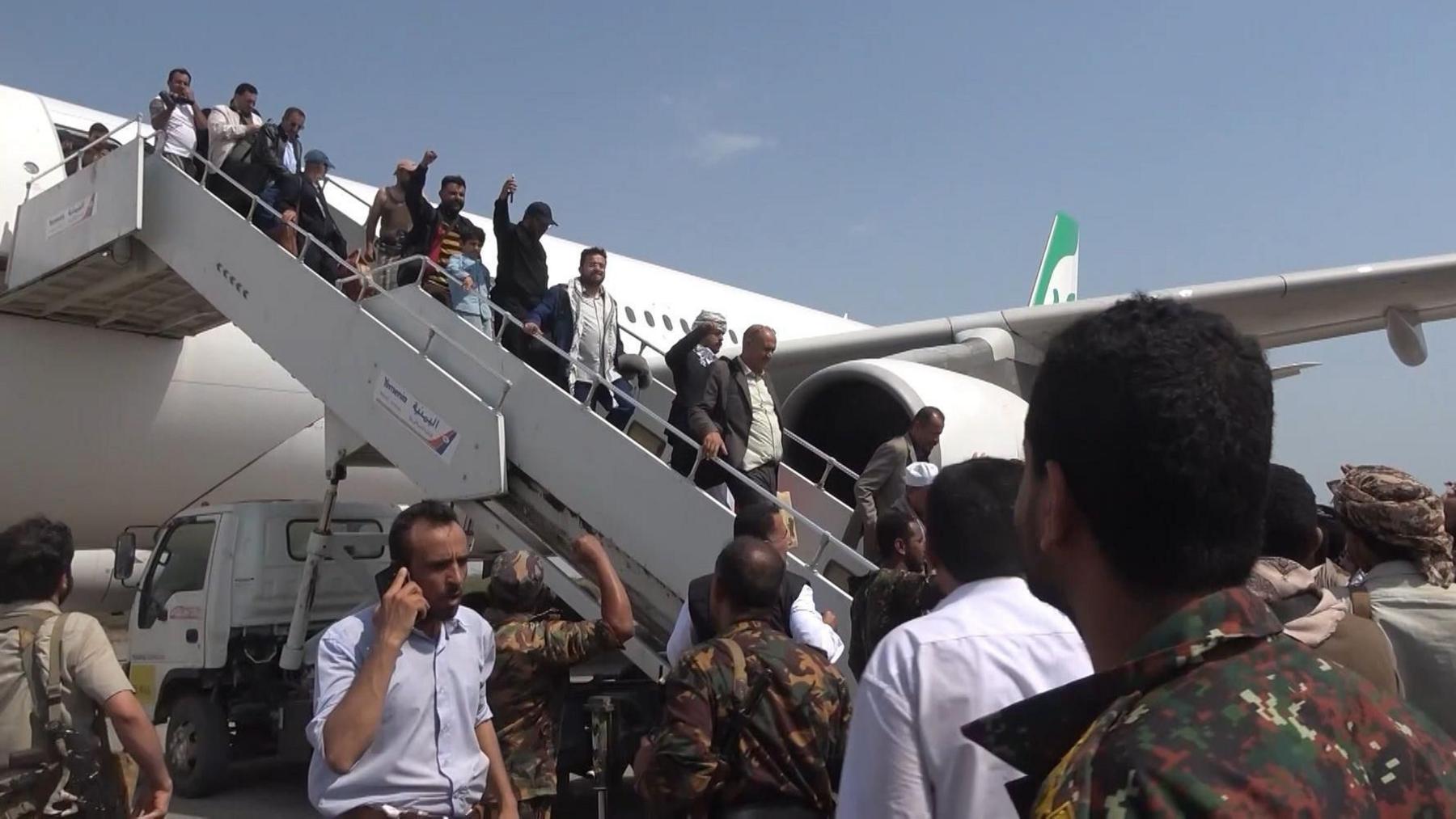 Screengrab from an Al Masirah TV handout video showing members of a Houthi delegation getting off an Iranian Mahan Air passenger plane at Hudaydah's airport, in western Yemen (13 July 2026)