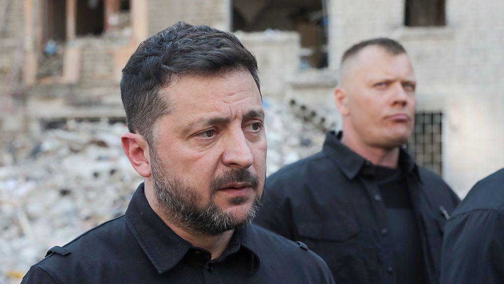 President of Ukraine Volodymyr Zelensky speaks to the press as he visits an apartment block in the Darnytskyi district severely damaged by a massive Russian missile attack