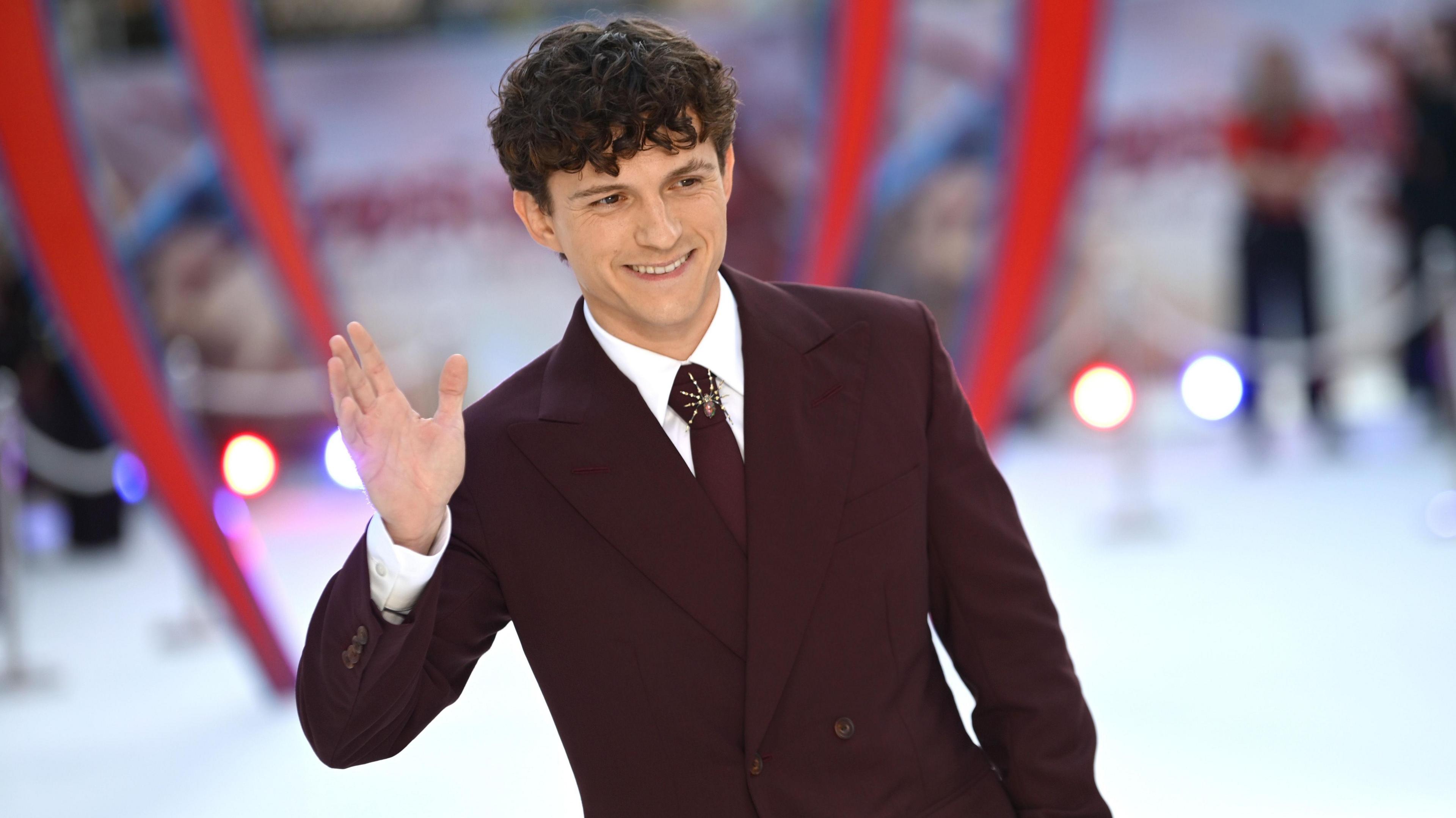 Tom Holland waving for cameras