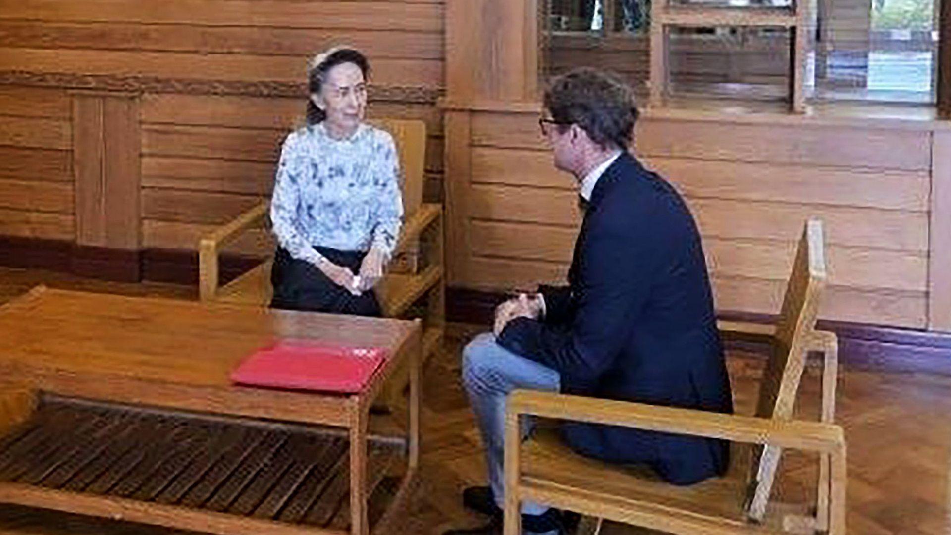 Former Myanmar president Aung San Suu Kyi talks to Arnaud de Baecque, resident representative of the International Committee of the Red Cross (ICRC)