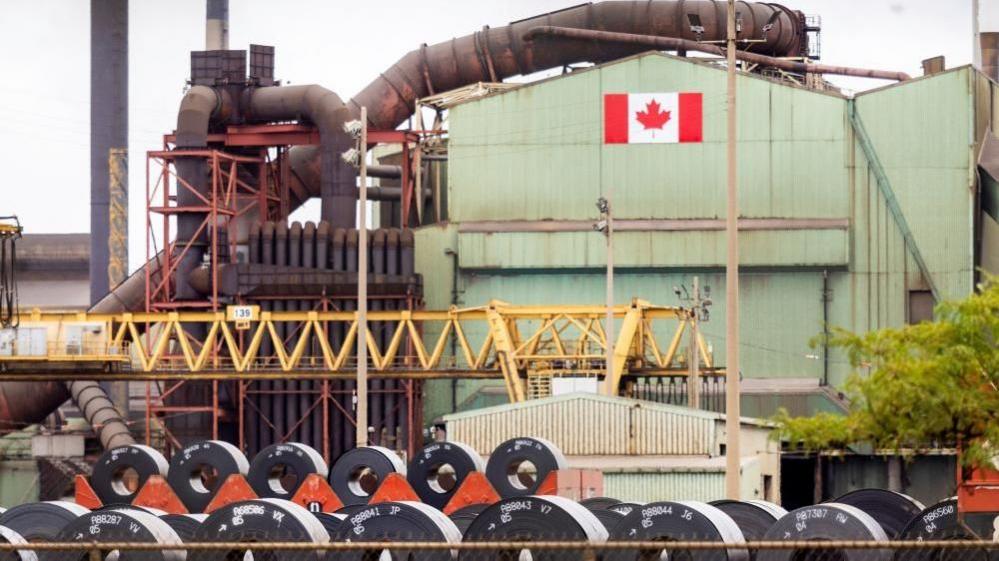 A Canadian flag visible on the ArcelorMittal Dofasco steel plant in Hamilton.