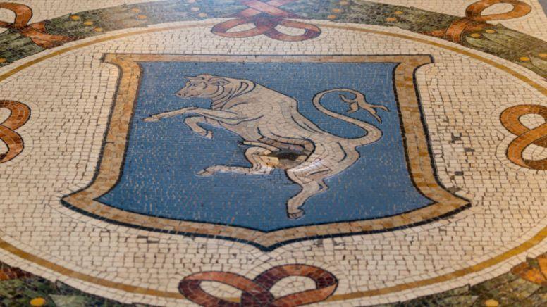 A small crater in the centre of the bull mosaic in the Galleria Vittorio Emanuele II in Milan, Italy.