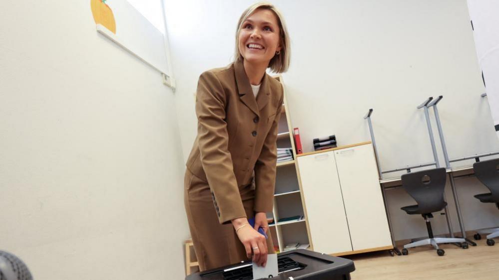 Iceland's Prime Minister Kristrun Frostadottir votes in the national referendum on resuming EU membership talks, at a polling station in Reykjavik