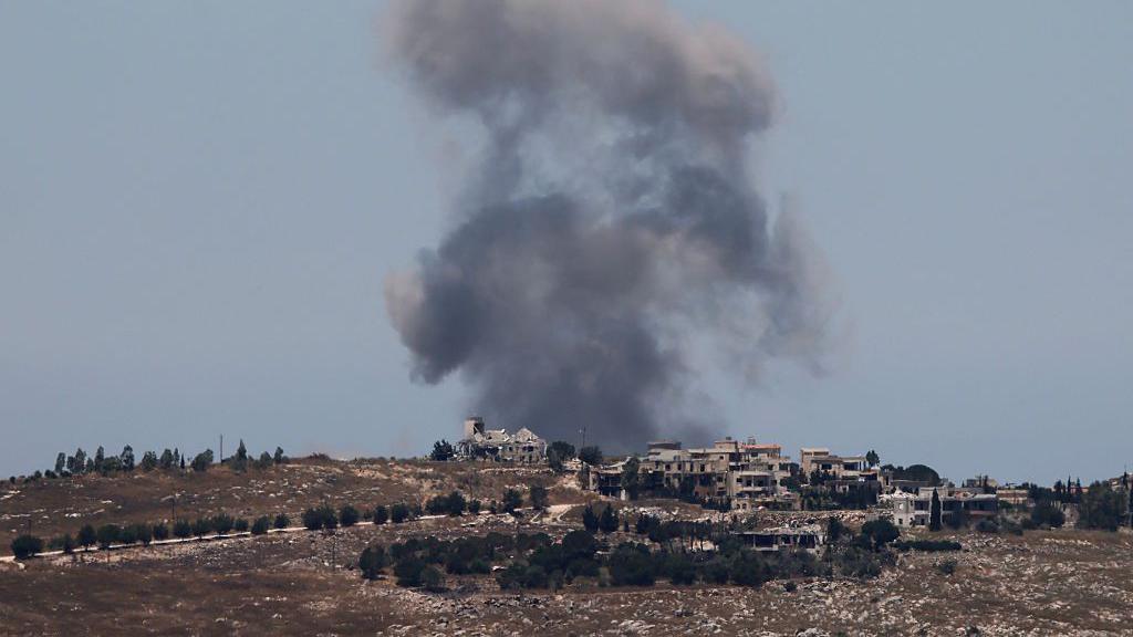 Smoke rises above houses following an Israeli strike near Nabatieh al-Fawqa last month.