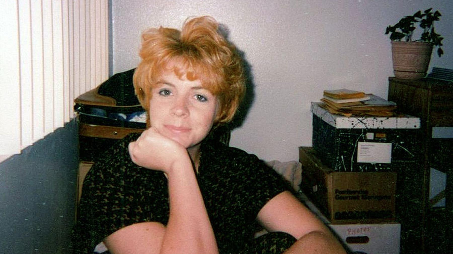Holly Ratchford poses for a photo in an office in the late 1990s.