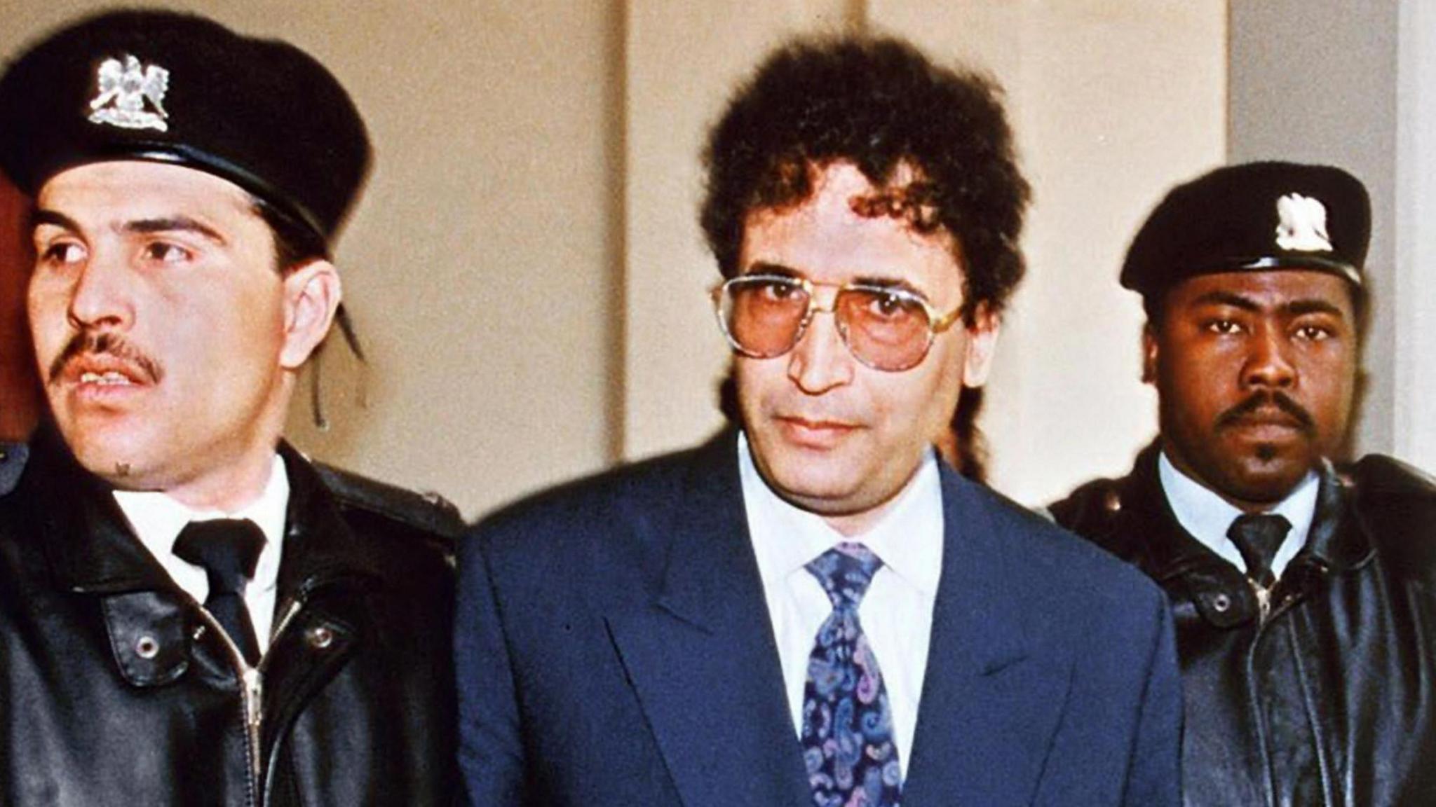 File photo taken February 18, 1992 in Tripoli shows convicted Lockerbie bomber Abdelbaset Ali Mohmet al-Megrahi (C) being escorted by security officers. The Libyan convicted of the Lockerbie bombing could be allowed to fly home to die over the next seven days, 21 years after the atrocity plunged Libya's ties with the West into a prolonged standoff, reports suggested on August 16, 2009.