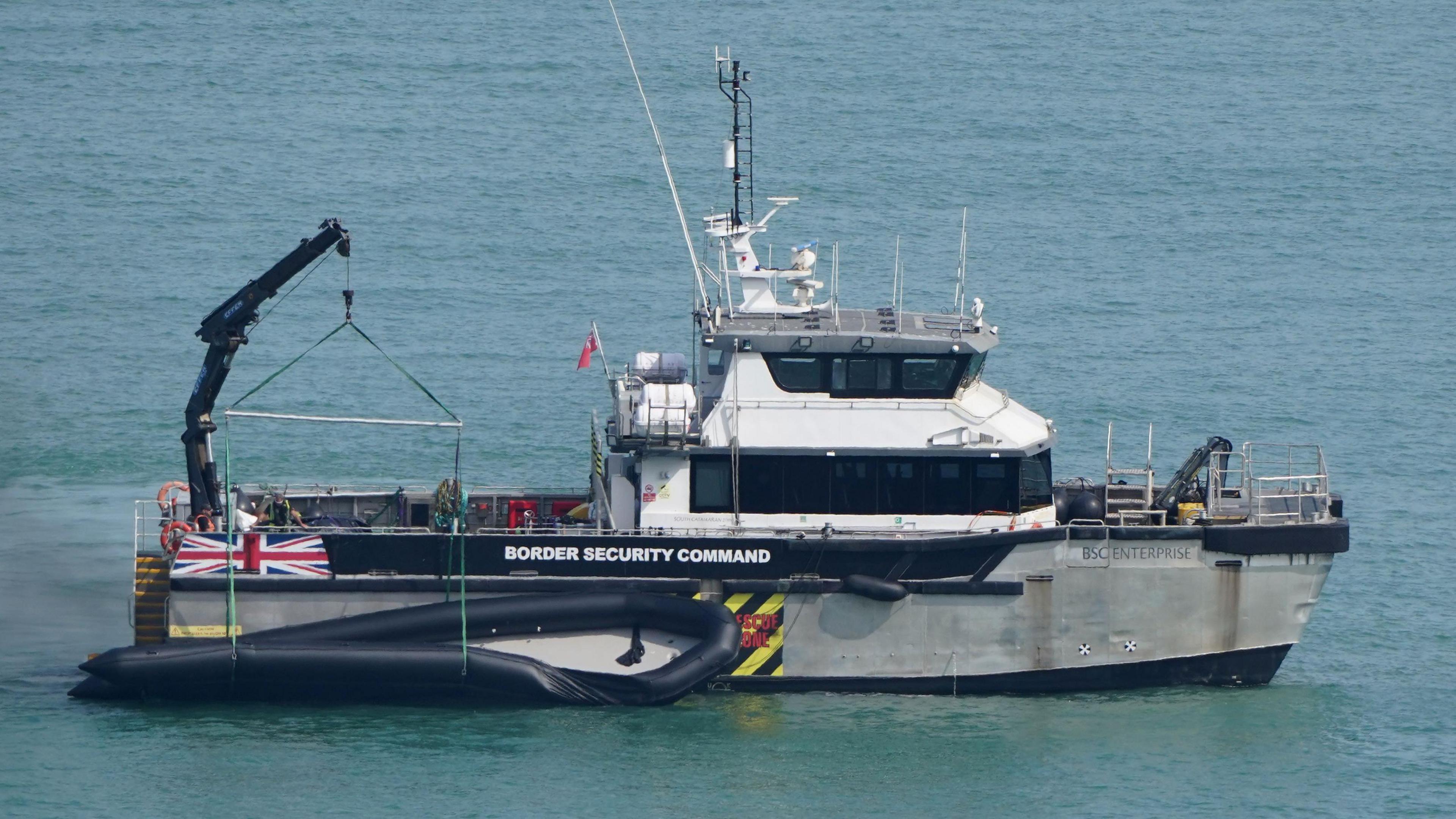 A Border Force boat with a dinghy.