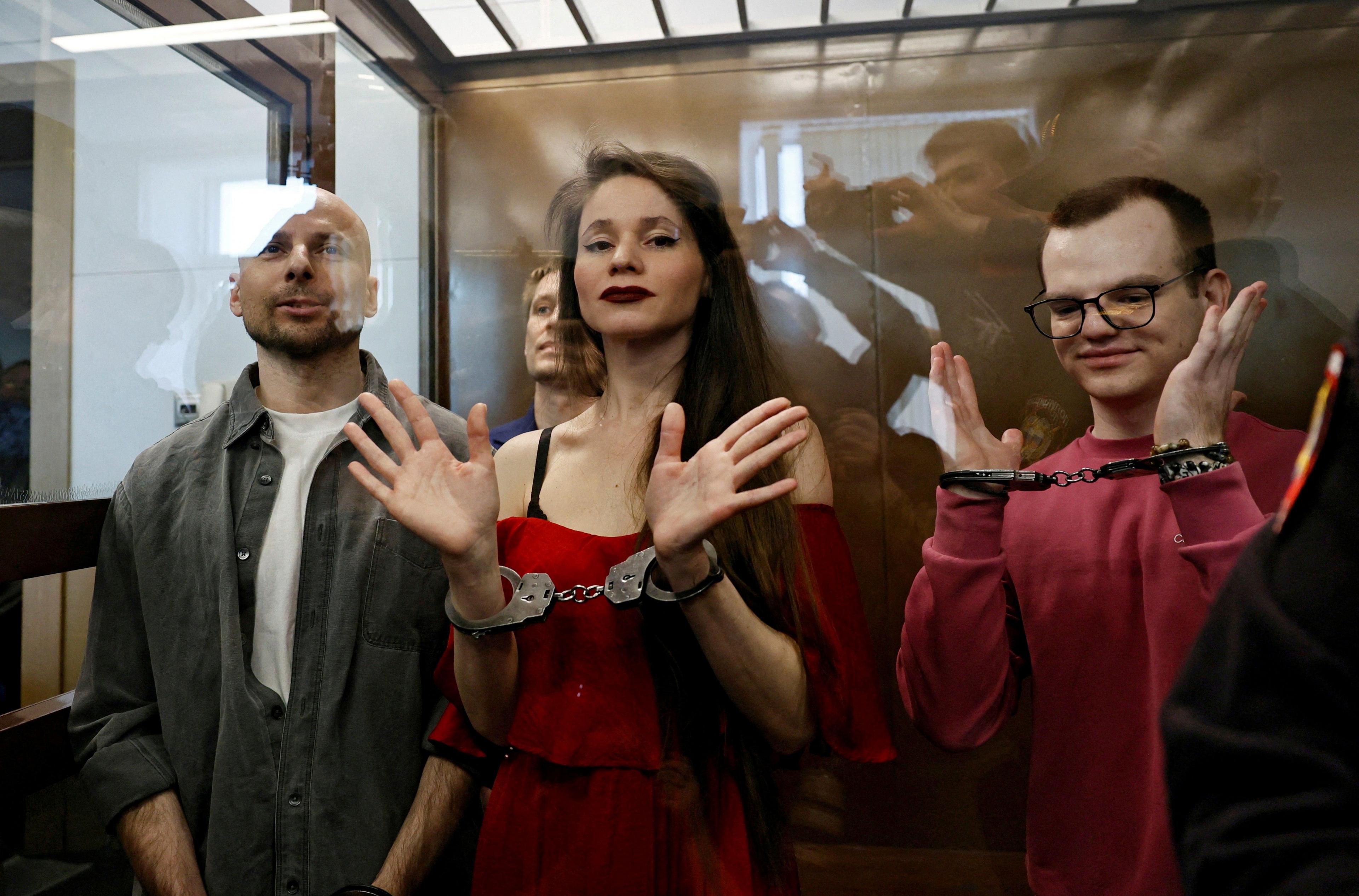 Antonina Favorskaya, Konstantin Gabov, Sergey Karelin and Artyom Kriger are handcuffed and standing in the dock during their trial.