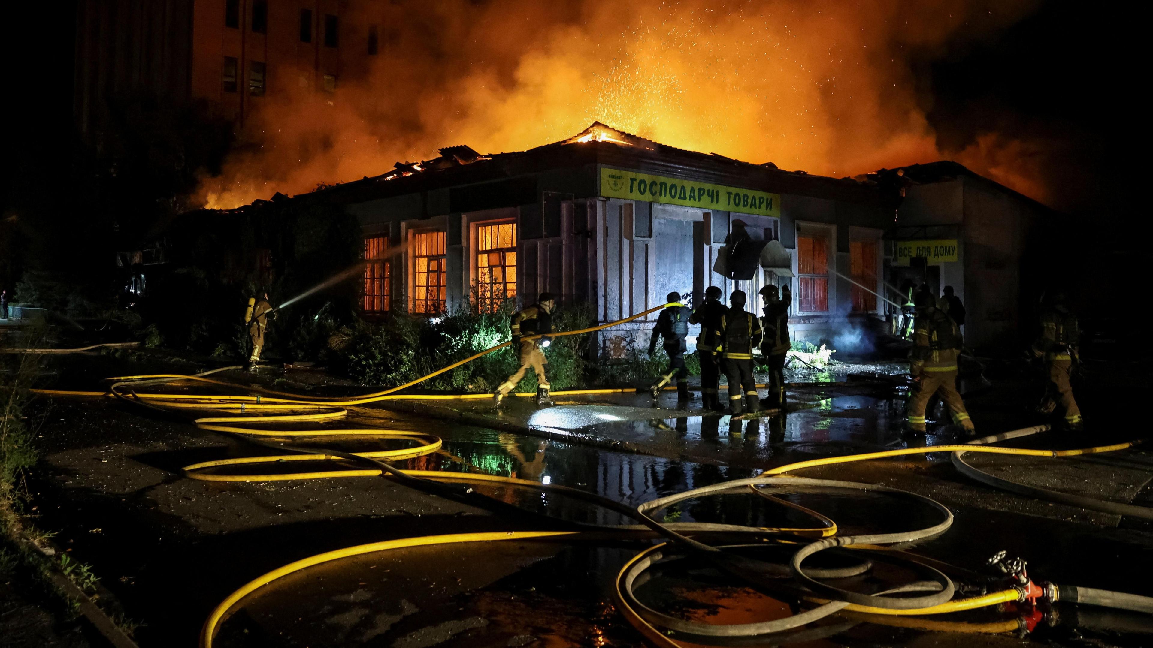 Firefighters work at a site hit by a Russian missile strike, amid Russia's attack on Ukraine, in Kyiv on 20 August.