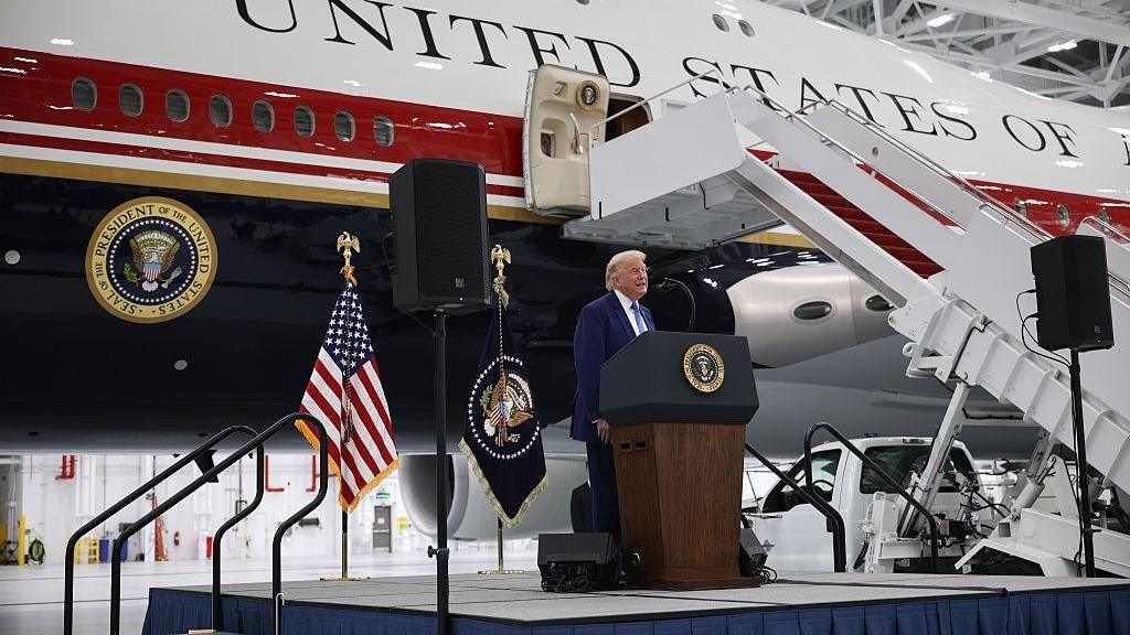 Trump in front of his Qatar-donated plane