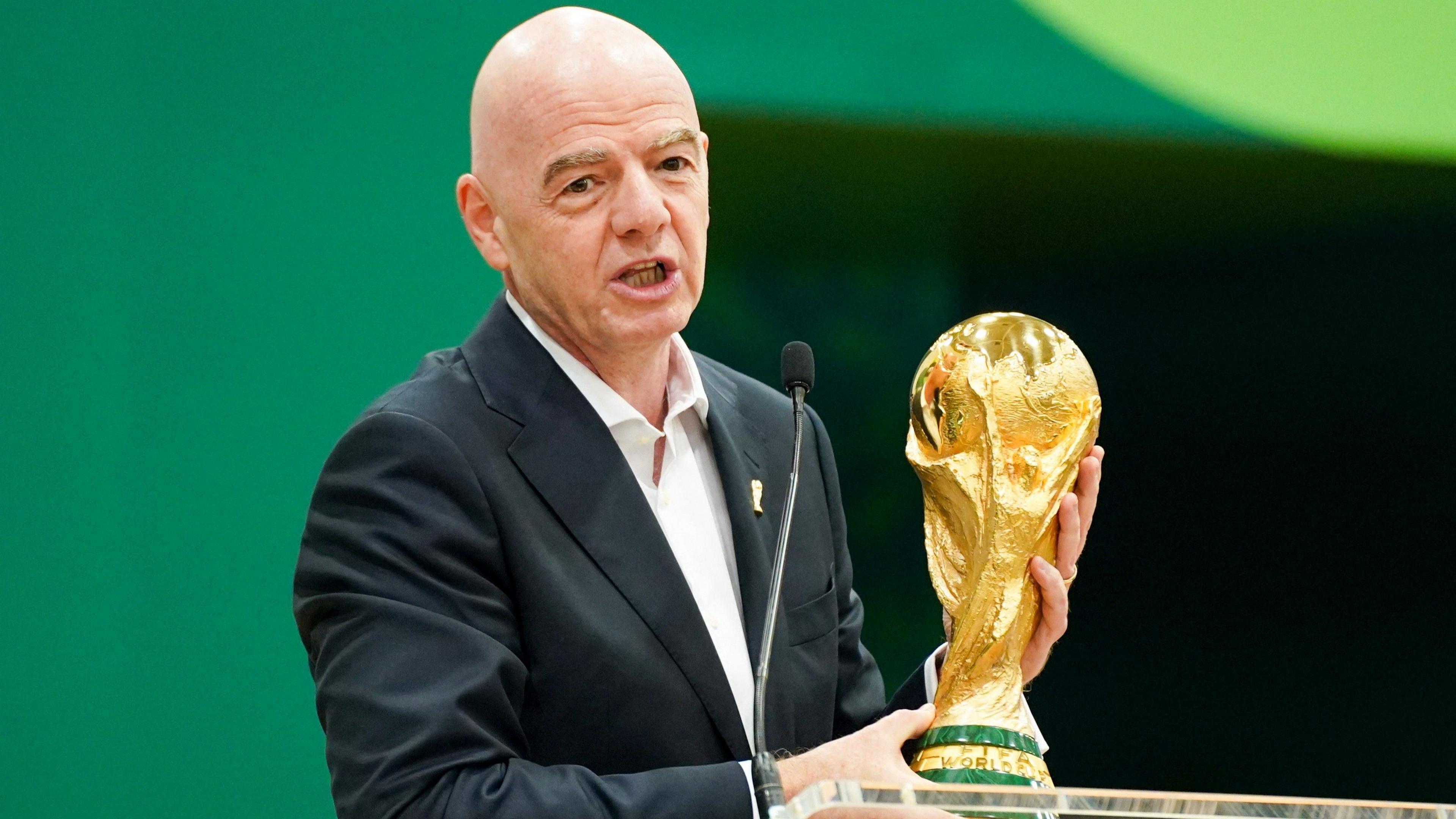 Gianni Infantino with the World Cup trophy at a pre-tournament news conference