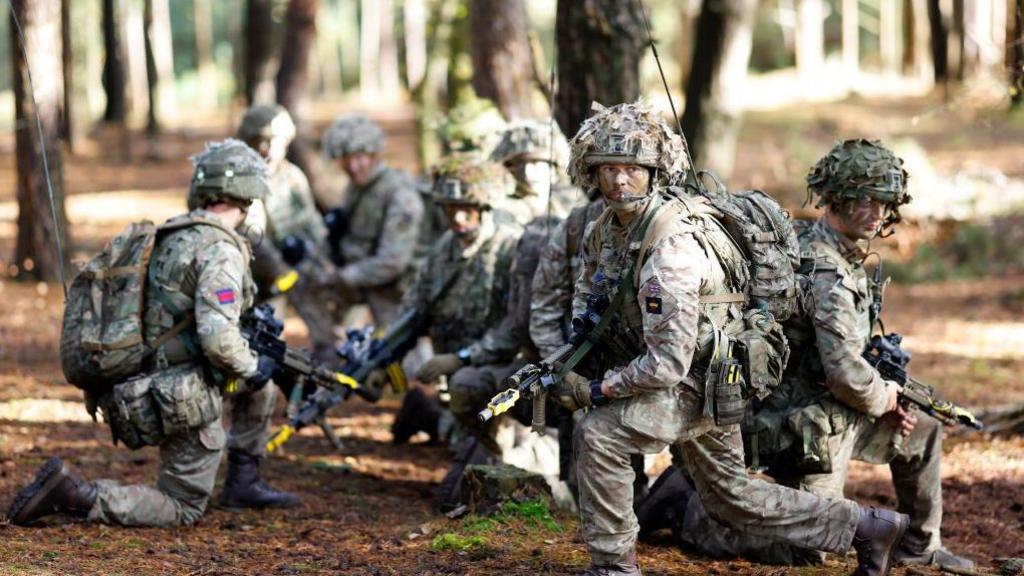 Soldiers of 1st Battalion London Guards take part in a training exercise on Hankley Common in Farnham