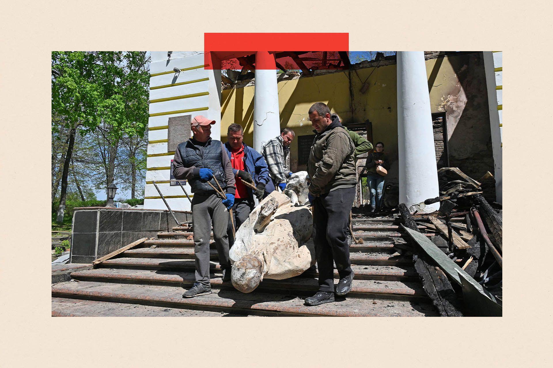 Museum workers carry the sculpture of Ukrainian philosopher Hryhorri Skovoroda from the destroyed building of the Hryhoriy Skovoroda National Literary Memorial Museum