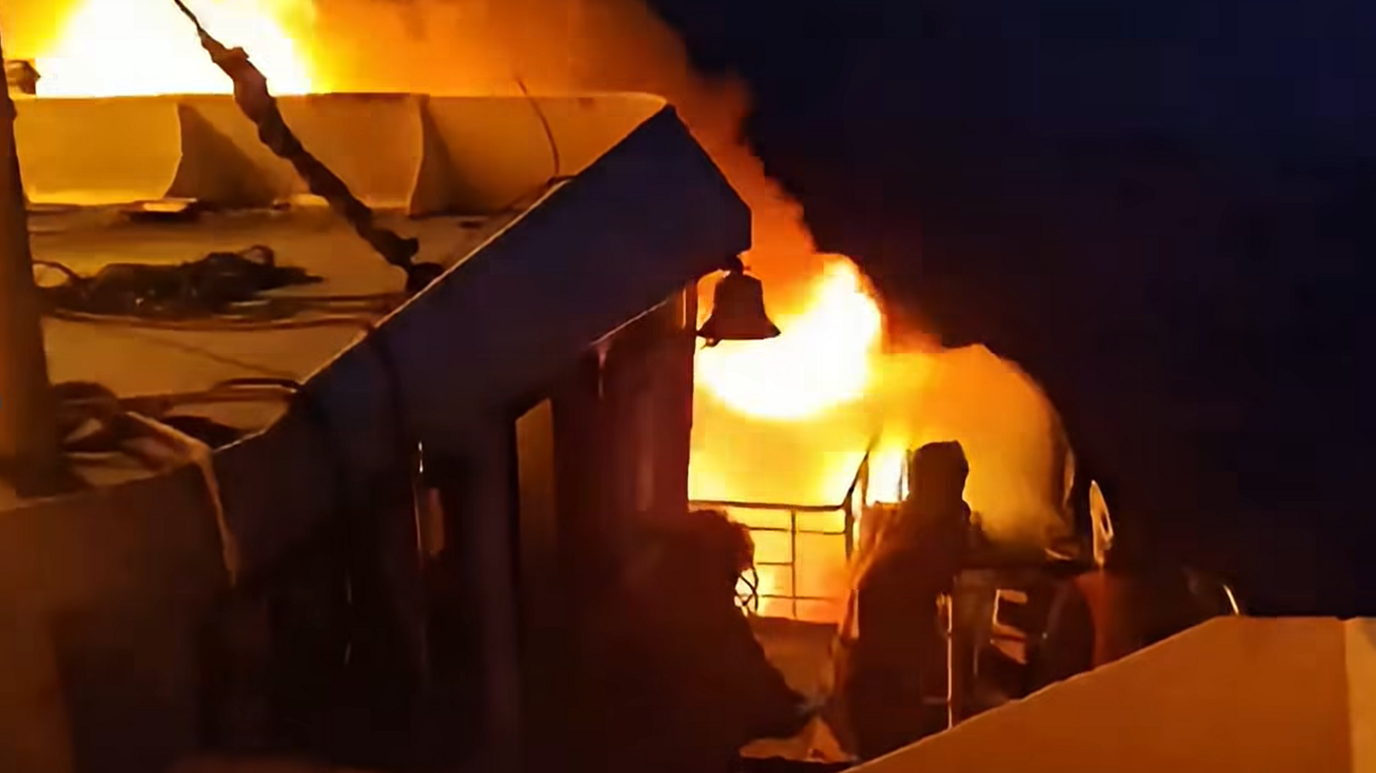 Flames engulf a ferry as a fire erupted in the night