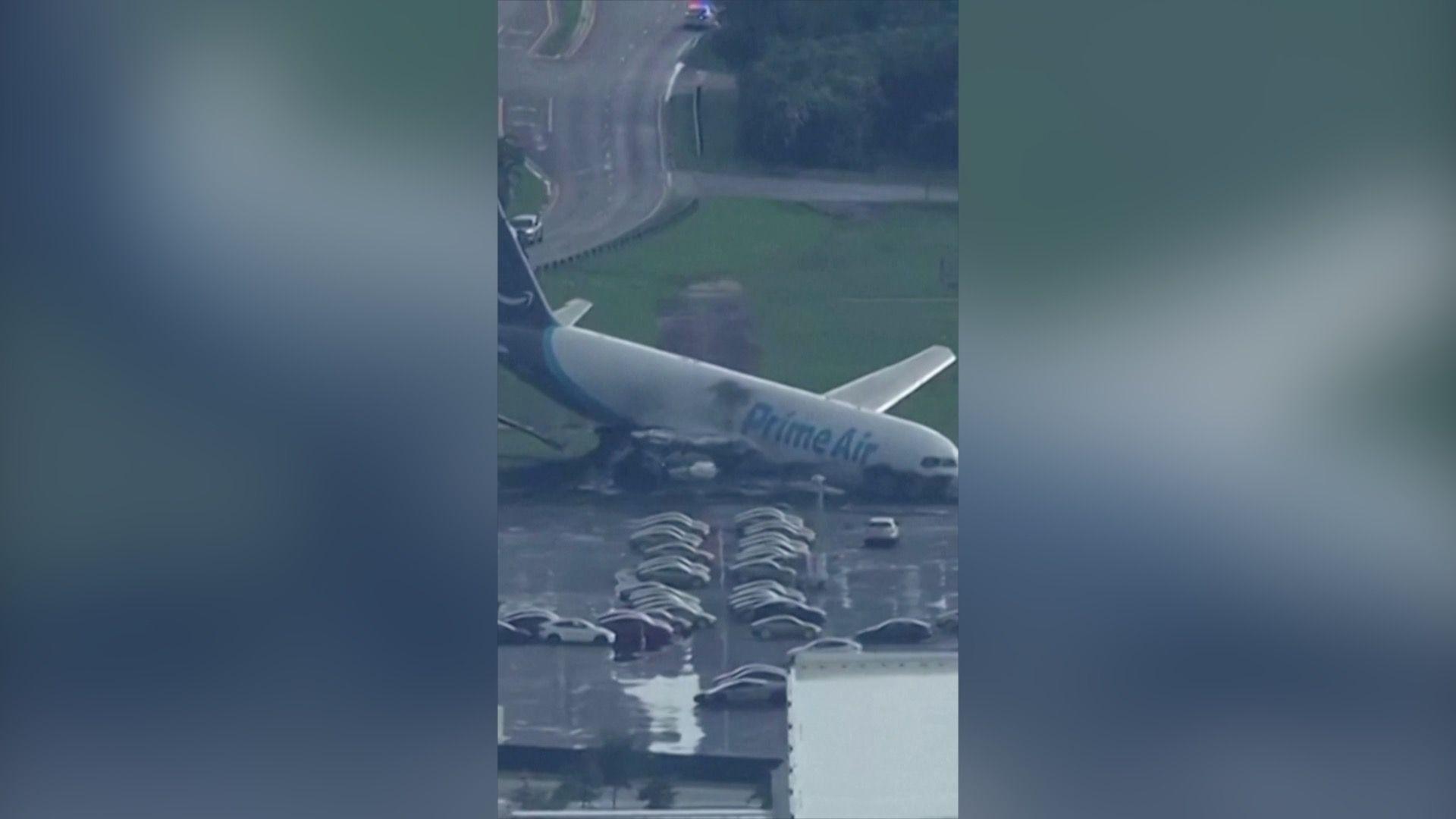 An aeroplane which has crashed in a car park.