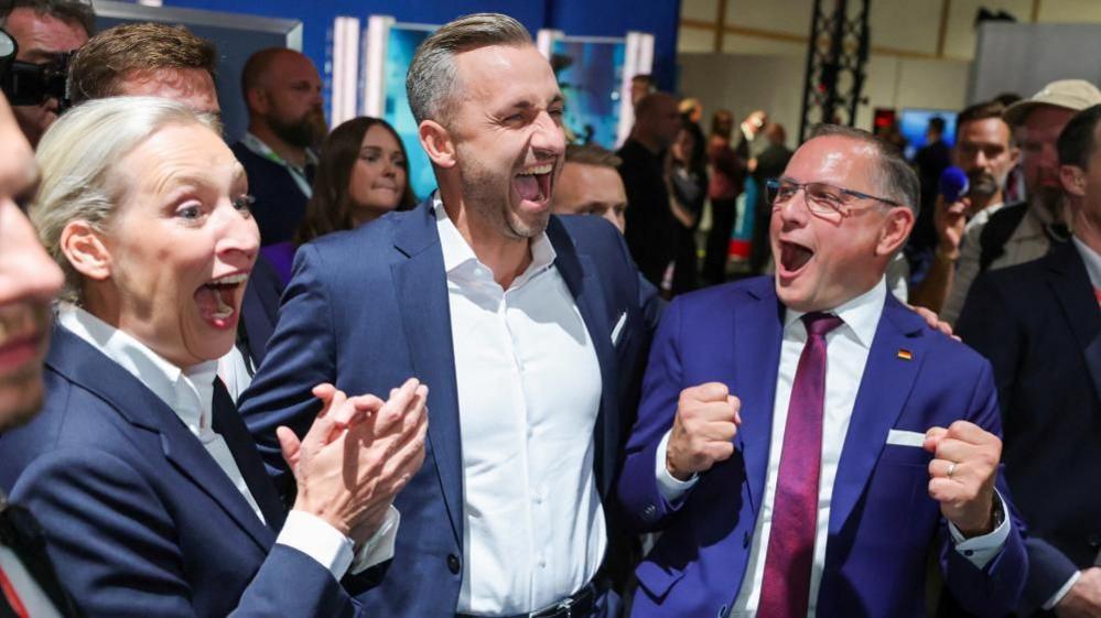 Top candidate of the far-right Alternative for Germany (AfD), Ulrich Siegmund, with party co leaders Alice Weidel and Tino Chrupalla, reacts after polls closed, on the day of the Saxony-Anhalt state elections