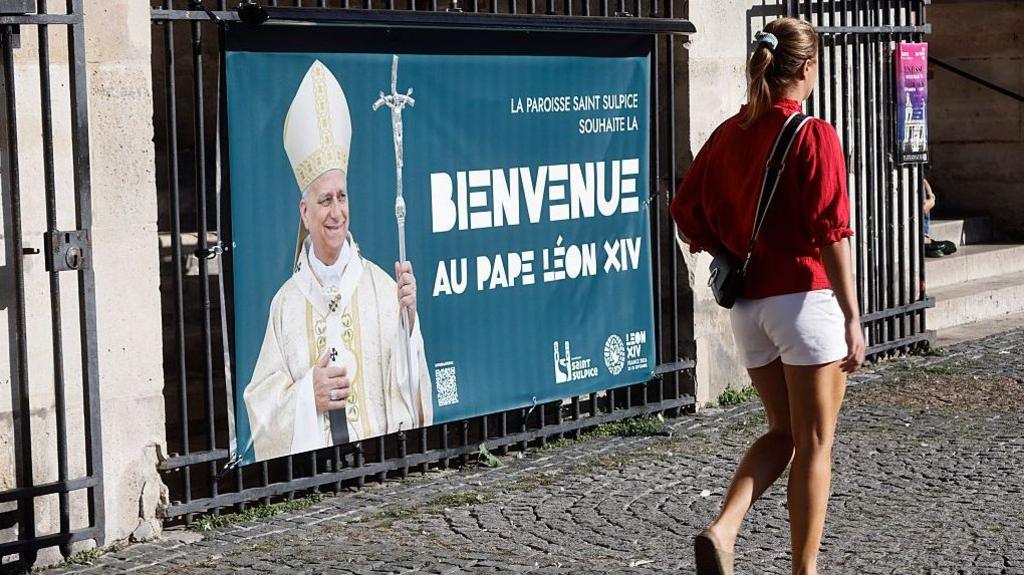 Displayed on the entrance gates of Saint-Sulpice Church, a banner extends a warm welcome to Pope Leo XIV in Paris, France, on September 21, 2026