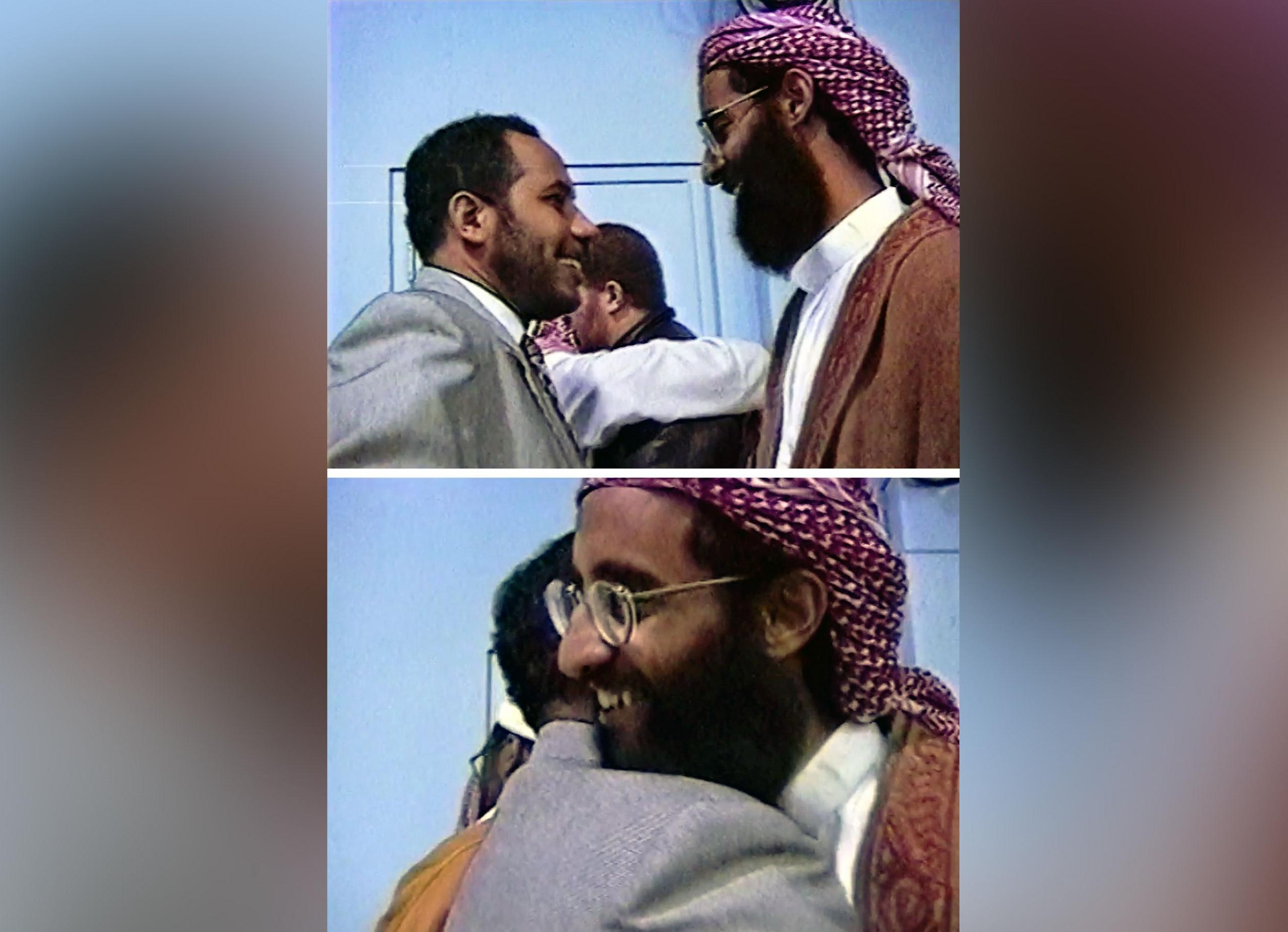 A composite of two stills from video footage showing two men, one in a suit and the other in Arabic dress. The top image shows the men about to embrace. The bottom shows the moment they do.