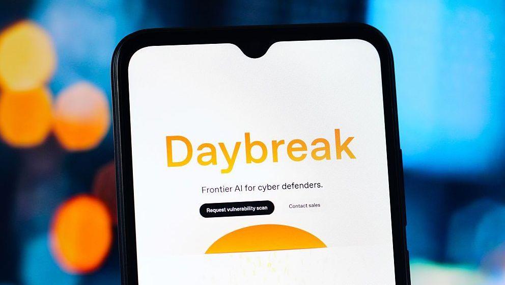 The word Daybreak in orange against a white phone background. Below it says Frontier AI for cyber defenders.