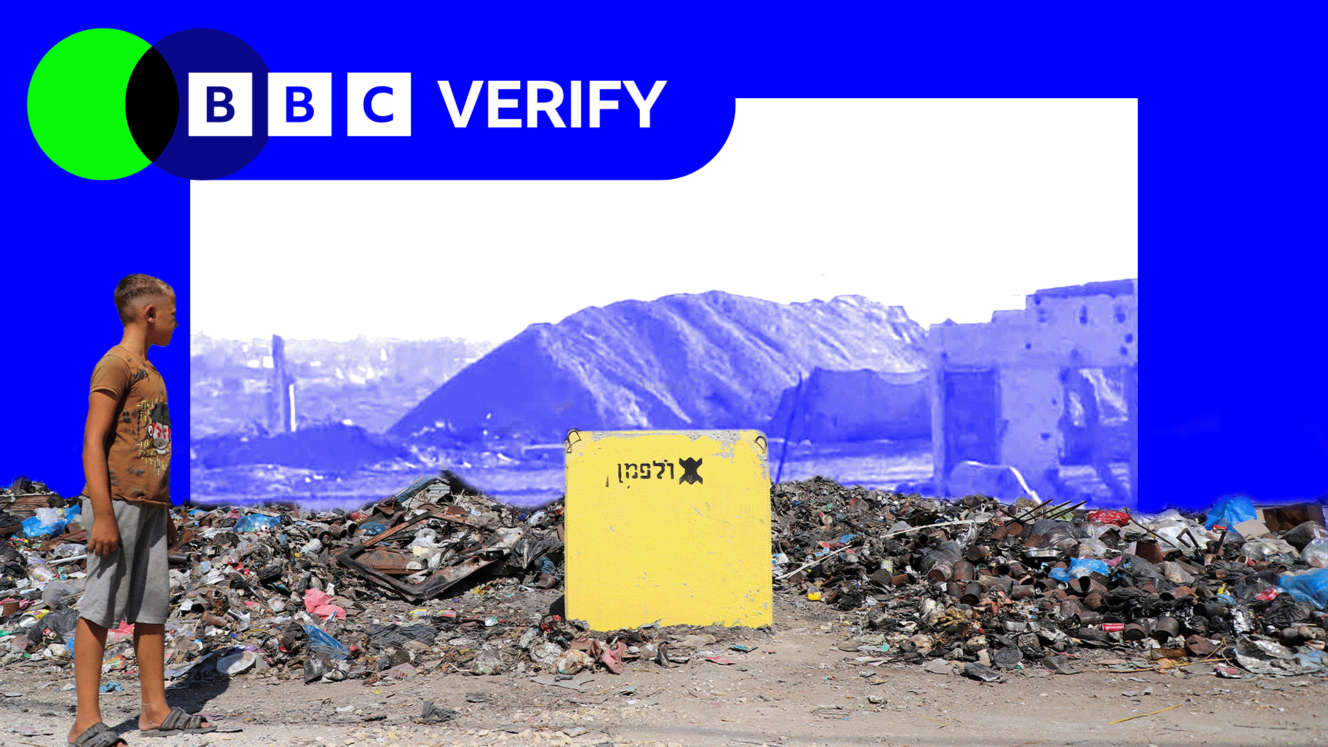 A young boy looks at a yellow block placed among rubble in Gaza. In the background an earth barrier is shown next to a building in blue scale inside a blue BBC Verify frame.