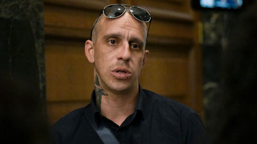 Georgi Filipov, 35 - one of the three suspects linked to the defacing of the Paris Holocaust memorial - speaks to journalists in a court in Sofia on 7 August 2024. Three Bulgarian men were tracked down and arrested on suspicion of defacing the Paris Holocaust memorial in mid-May, Bulgaria's state security agency (SANS) announced.
