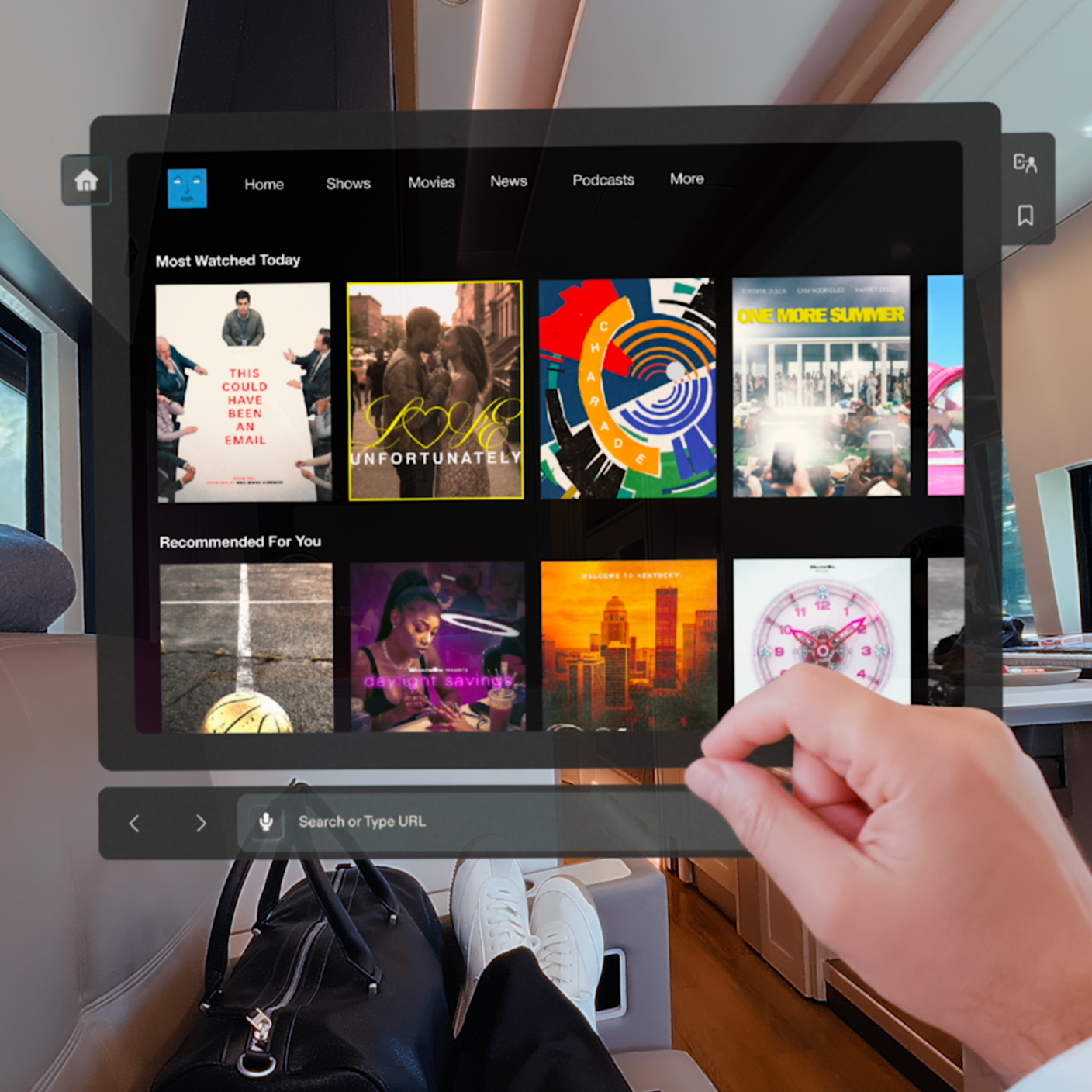 A person interacts with a screen on the glasses. It displays a few tv shows and movies which can be watched on the device.