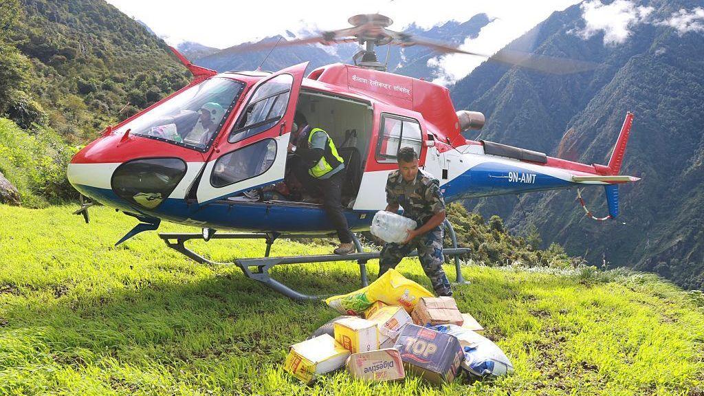 A Nepal Armed Police Force personnel unloads relief supplies from a helicopter for flood affected people in Nepal's Rasuwa district on September 1, 2026.