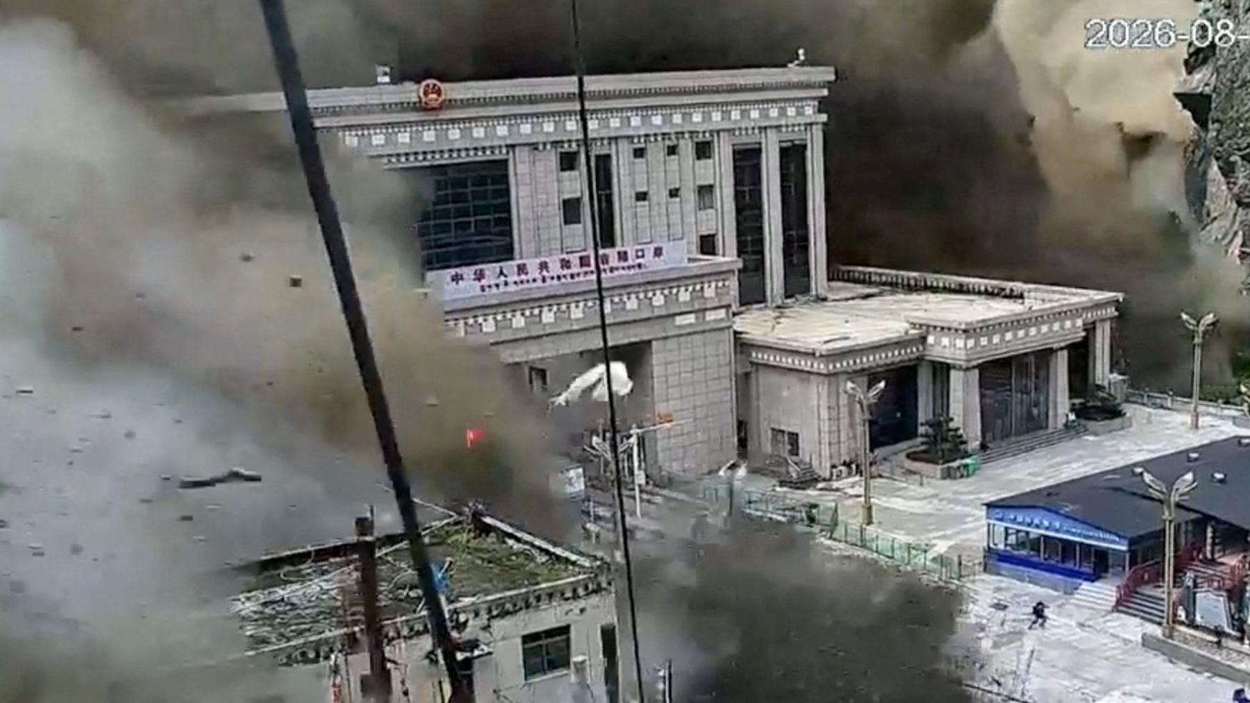 CCTV footage shows people fleeing as a wall of mud and water destroys buildings at the Nepal-China border in Gyirong, Tibet, China, on August 26, 2026.