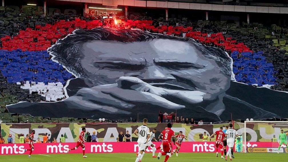 Red Star Belgrade supporters form a tifo depicting the late former Bosnian Serb military chief Ratko Mladic during the Serbian SuperLiga football match between Red Star Belgrade and Partizan Belgrade in Belgrade, Serbia, on September 6, 2026.