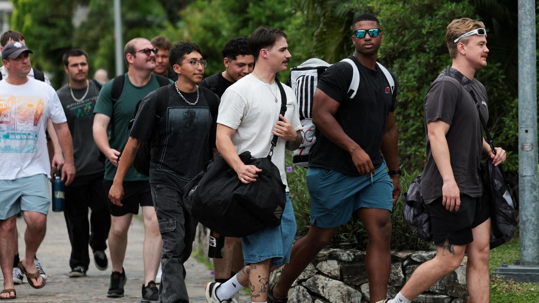 US sailors, in civilian clothing, walk outside a hotel.