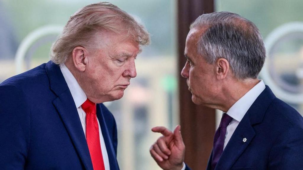 Trump listens as Mark Carney gestures as he speaks to him at a summit in France in June