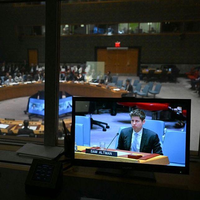 Sam Altman is seen on a screen speaking at the UN