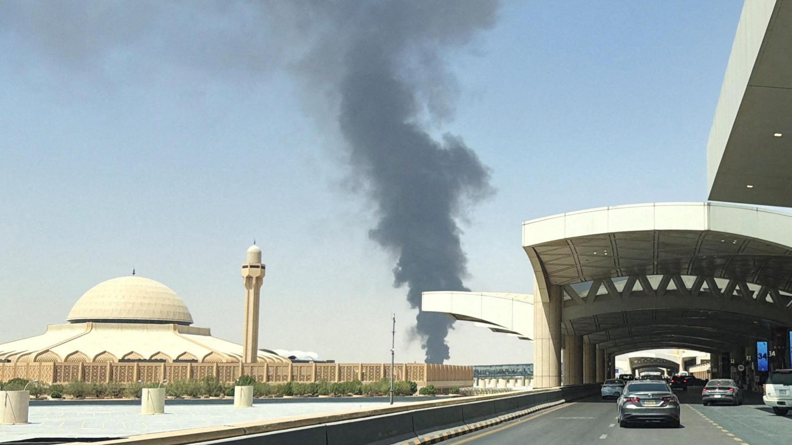 arge plume of black smoke rises from the fuel storage area at King Khalid International Airport