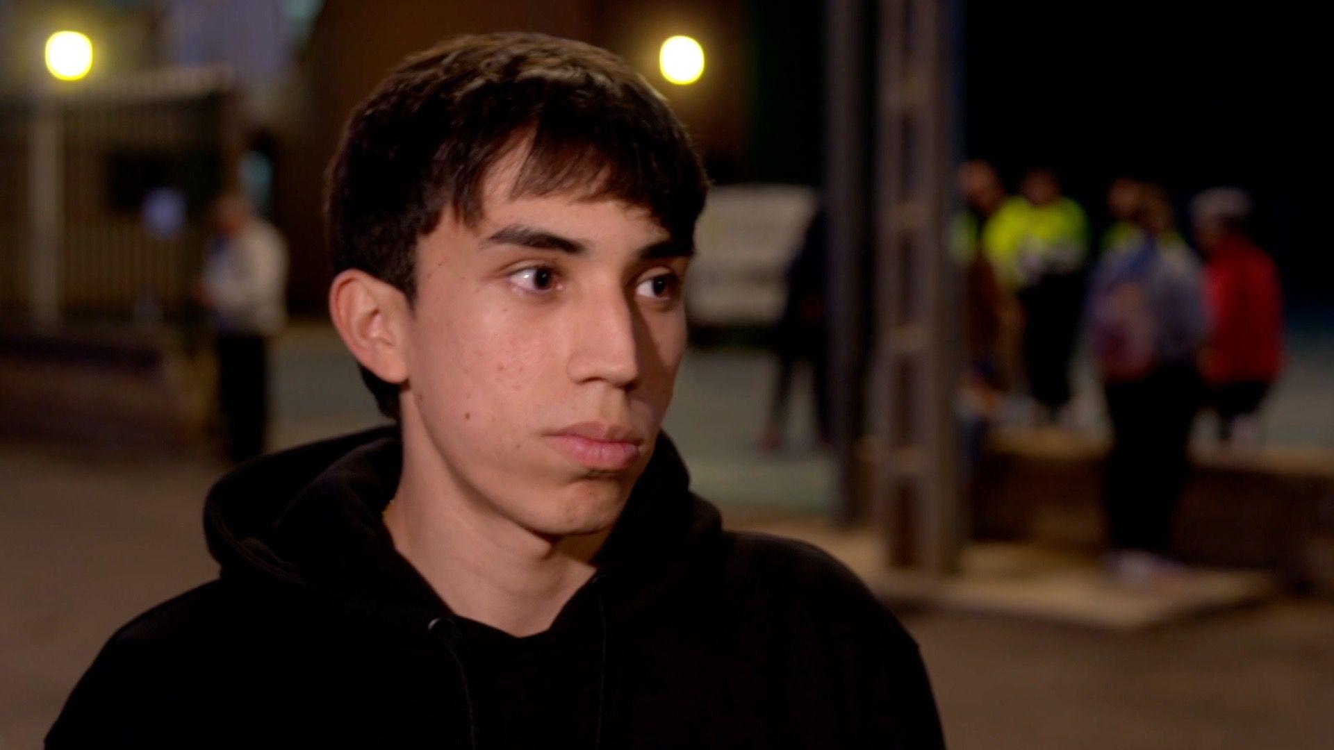 A young man with a black hoodie giving an interview