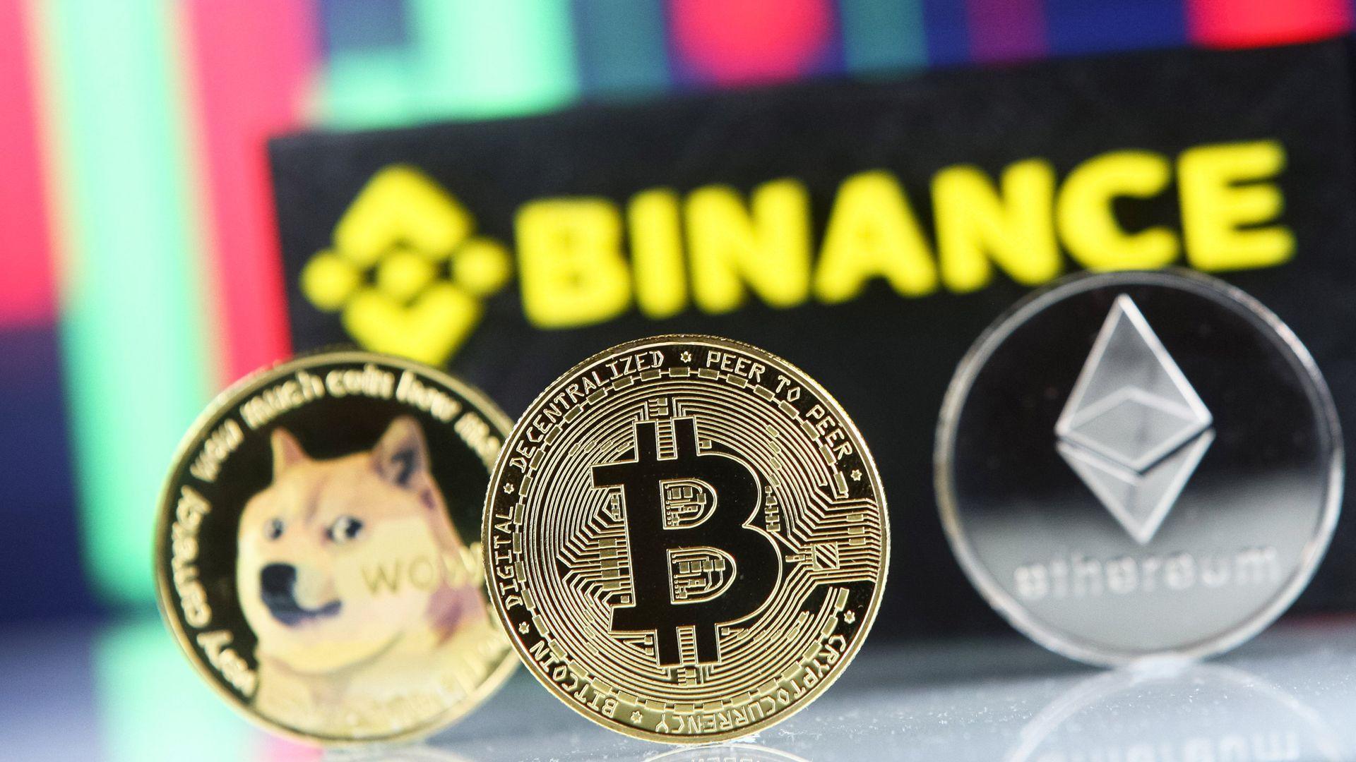 Binance logo is seen together with representations of cryptocurrencies. File photo