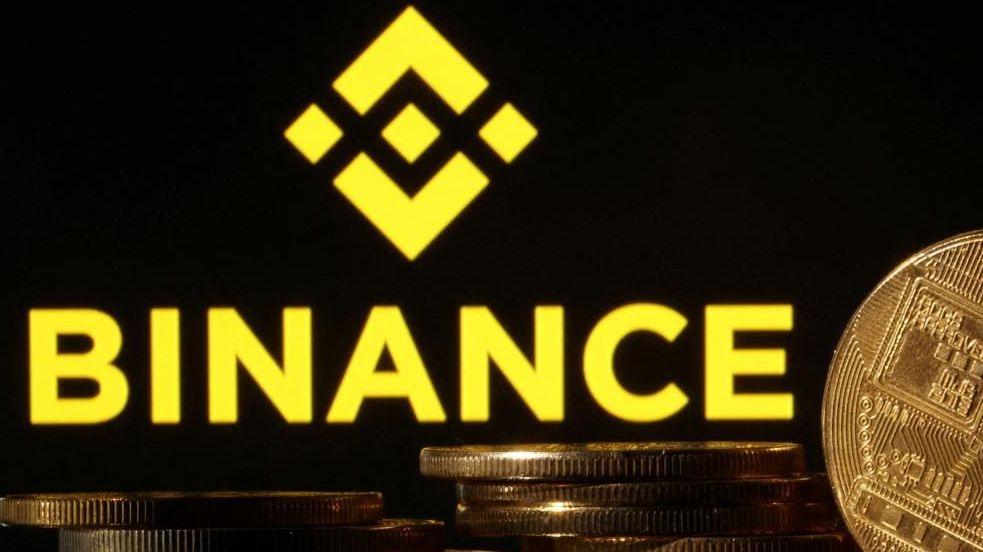 Binance logo is seen together with representations of cryptocurrencies. File photo