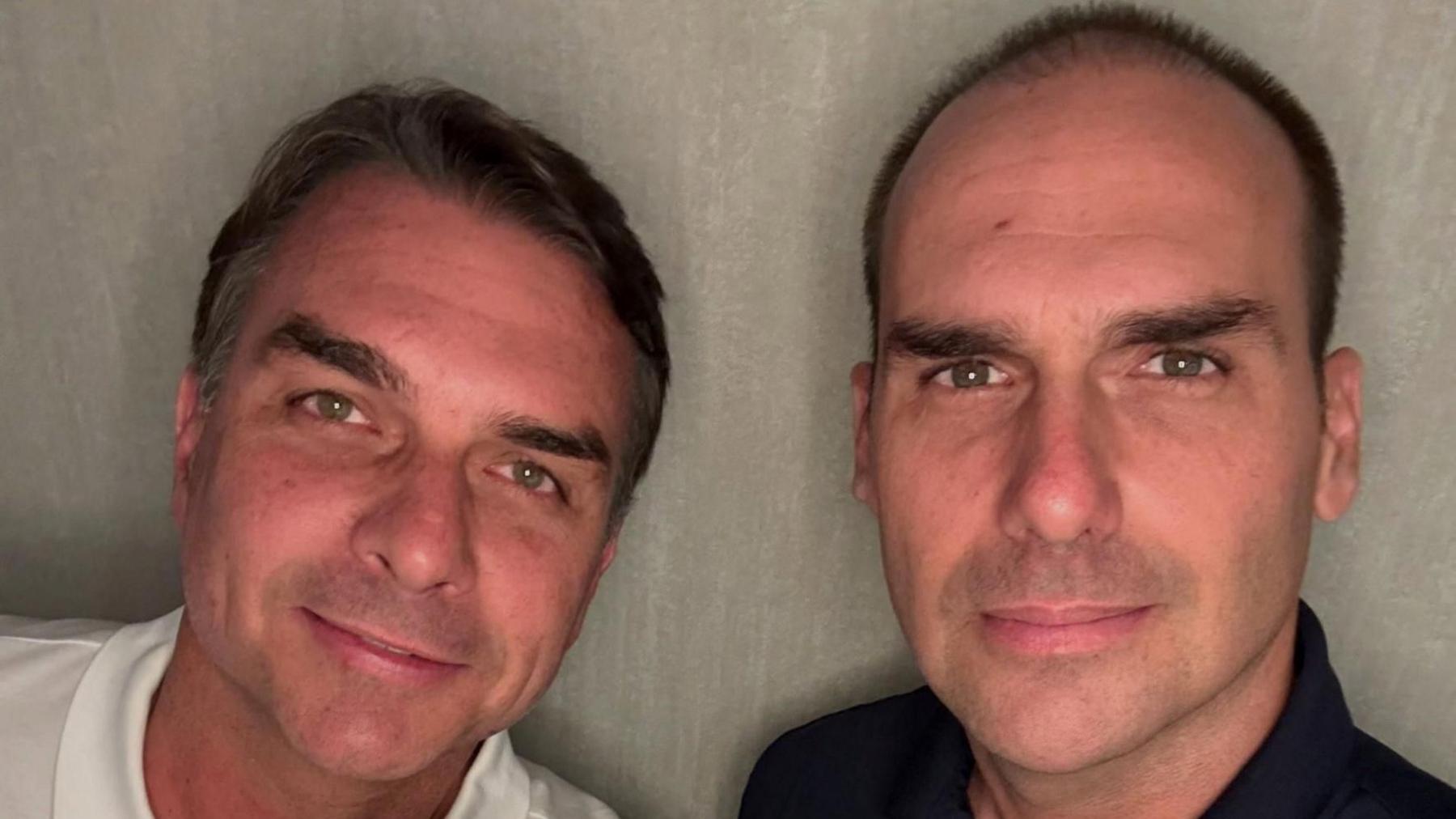 Flavio Bolsonaro and his brother, Eduardo Bolsonaro, smile at the camera as they pose at an unidentified location, in this picture obtained from social media and released on October 28, 2026.